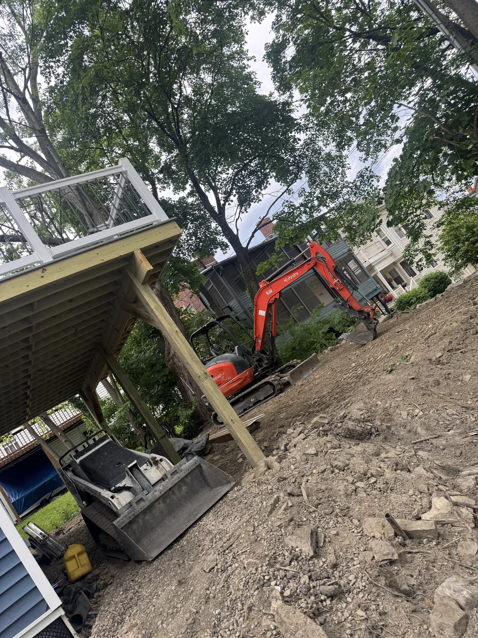 Excavation equipment working beside active deck construction at the Corning project