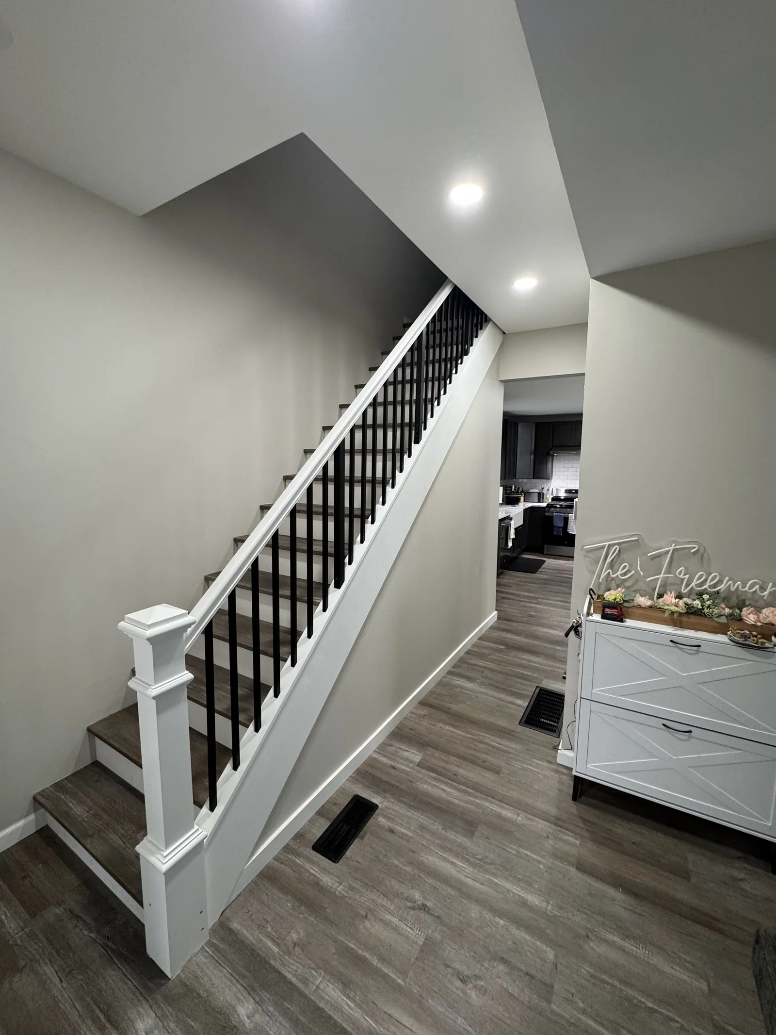 Finished Corning staircase with wood treads and black balusters